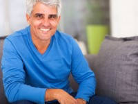 Happy man on a couch at home