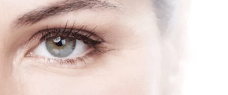 Partial face showing green eye and lashes