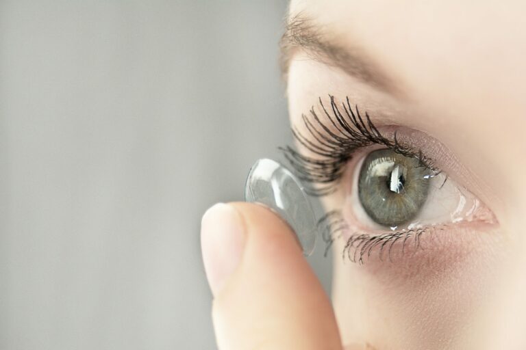 Woman putting contact lens in her eye