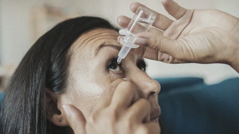 Woman using eye drops