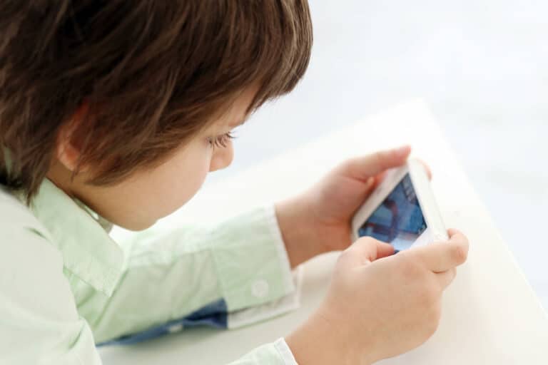 Kid playing a game on a cell phone