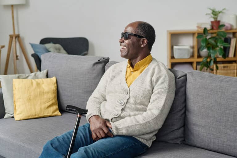 blind man sitting at home