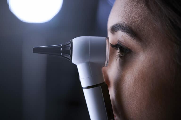 female doctor using otoscope for examination