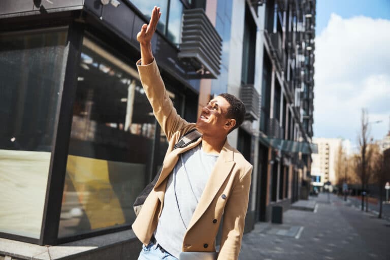 Close up of pleased man keeping smile on his face while looking upwards